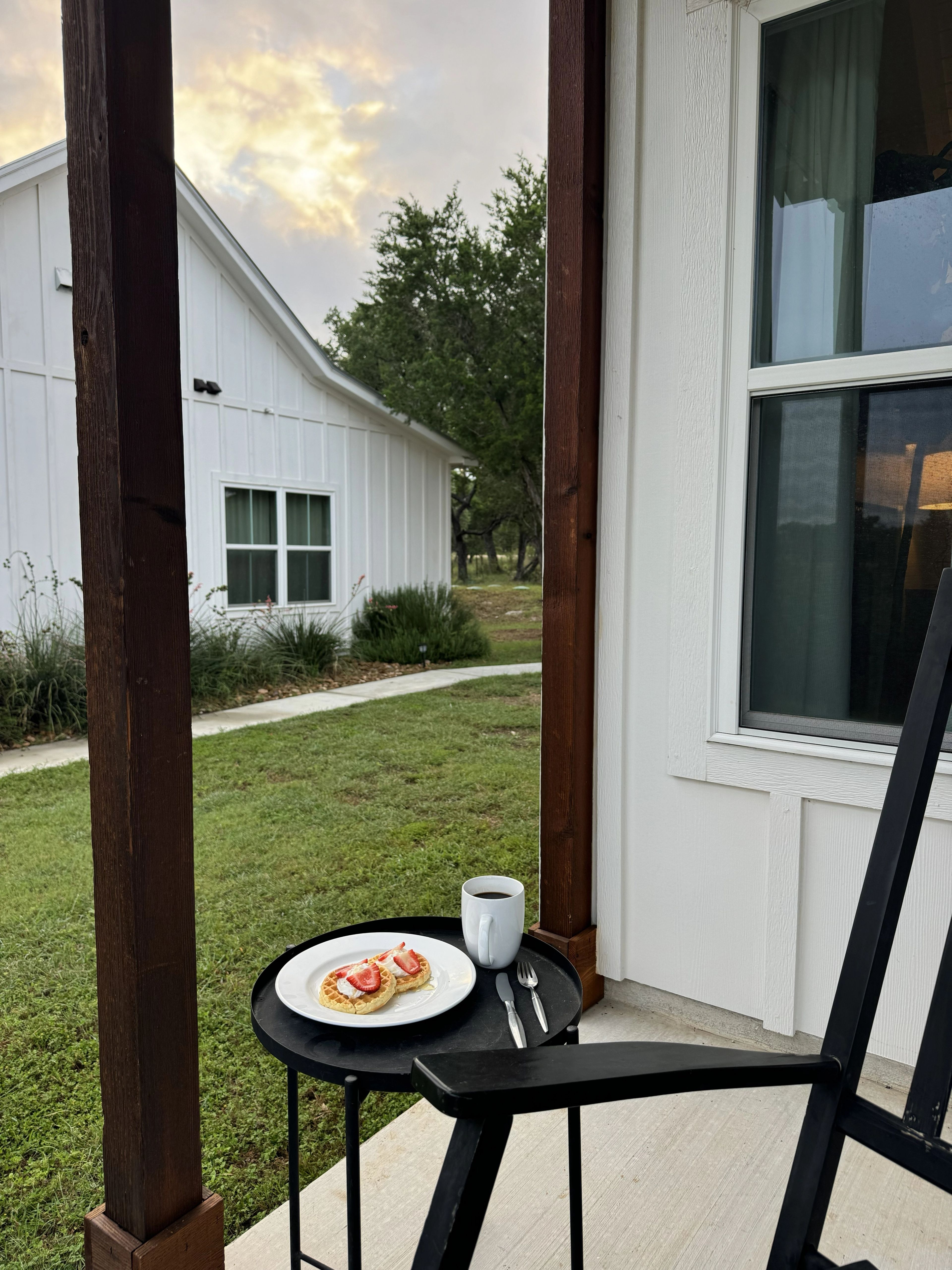 Coffee and waffles on a small table on the Summermoon porch at sunrise
