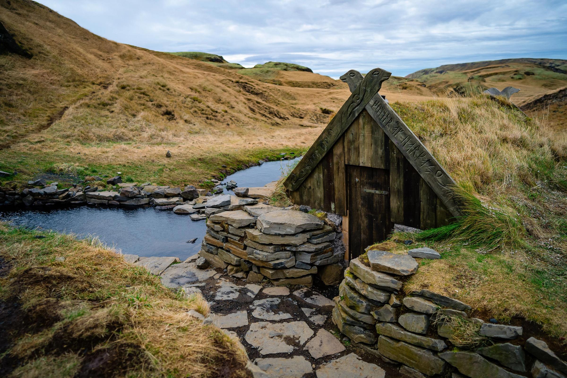 A serene image of Hrunalaug, one of the most popular hot springs in Iceland