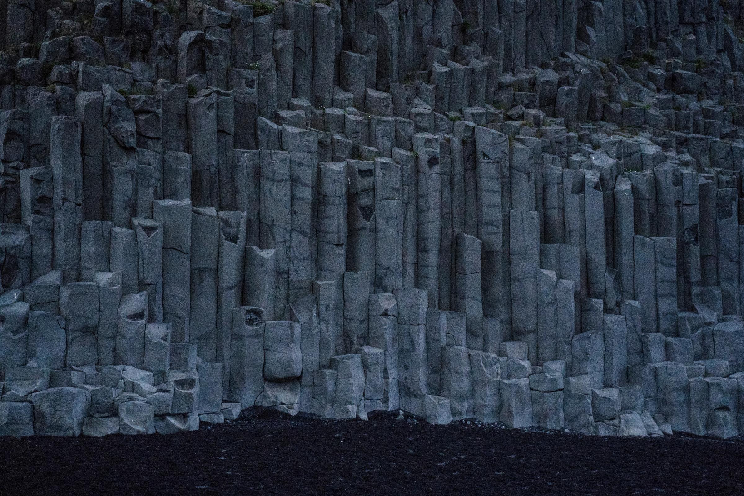 basalt columns on a black sand beach