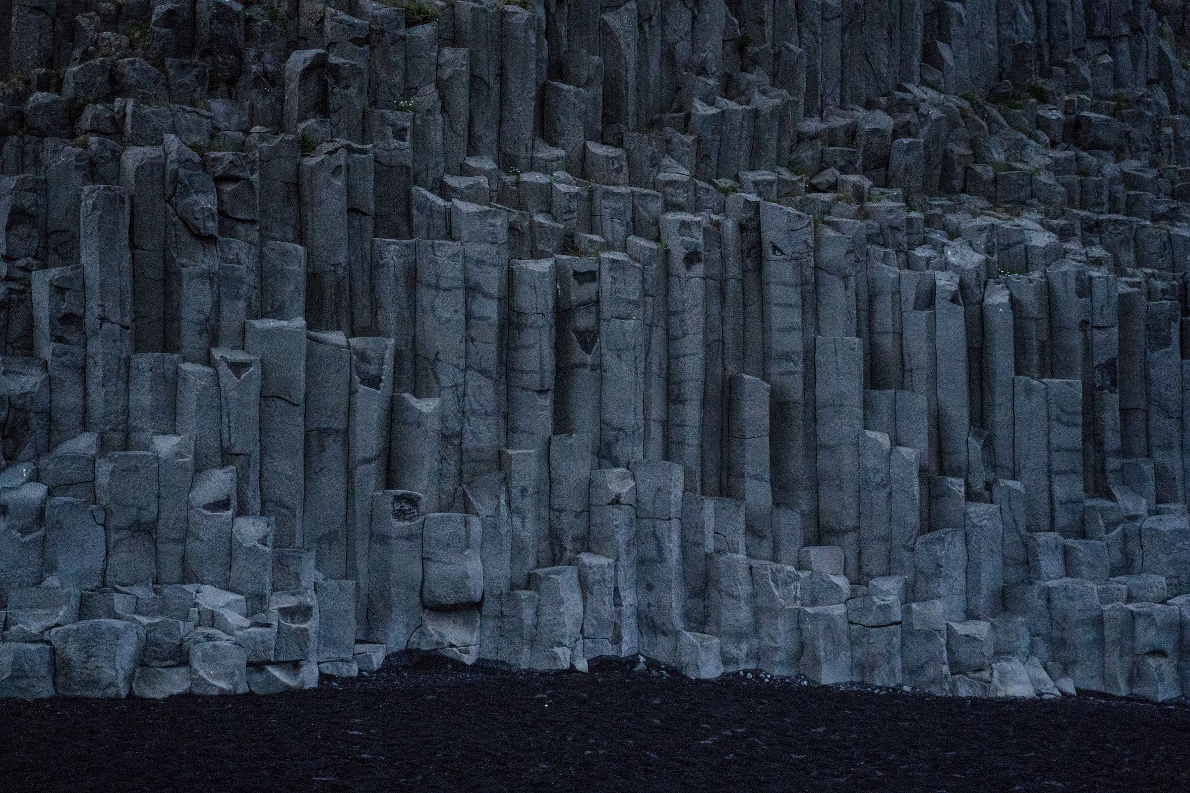 basalt columns on a black sand beach