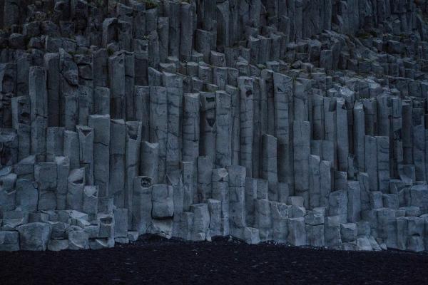 basalt columns on a black sand beach