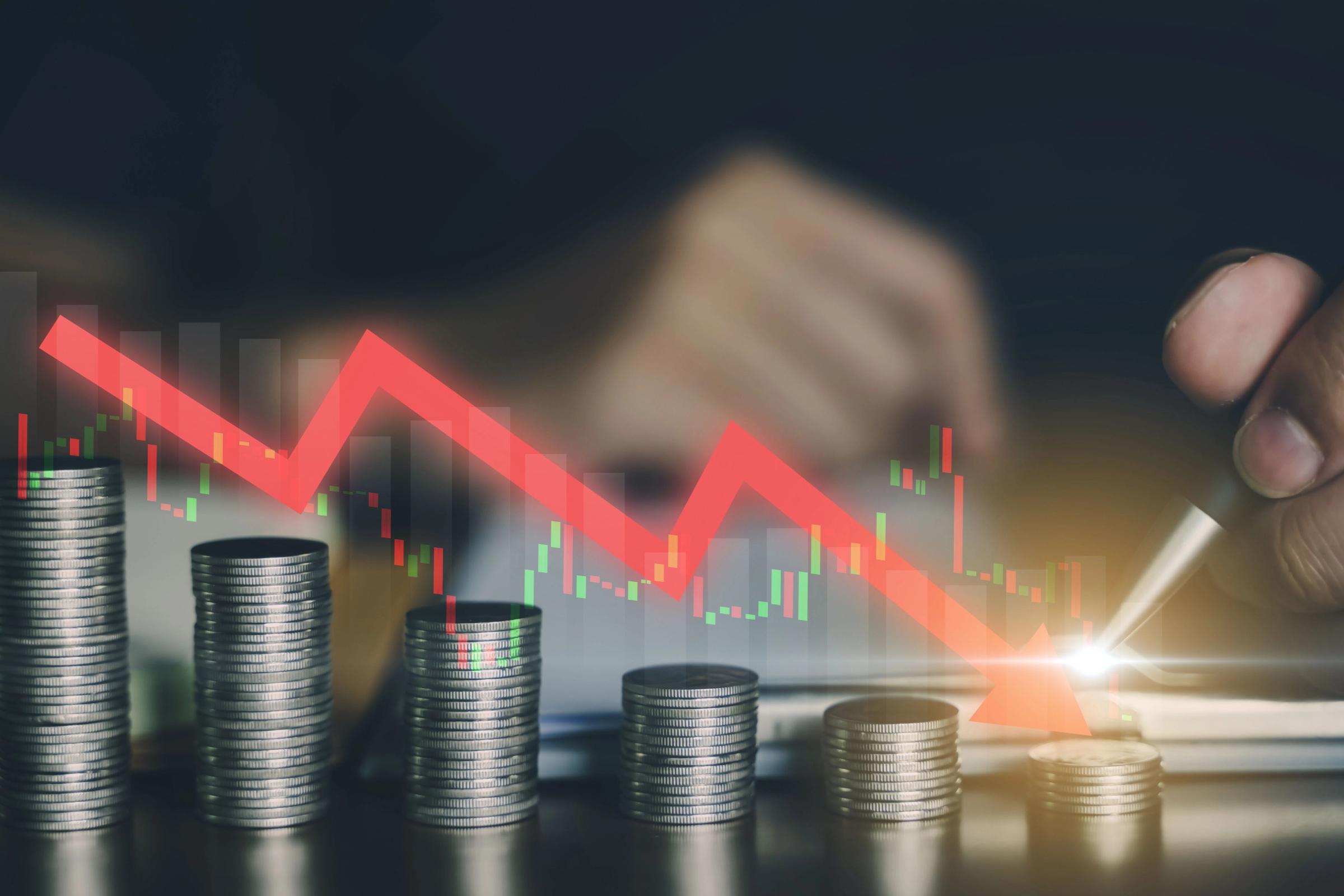 Exchange rate fluctuation Arrow going down on top of a coins