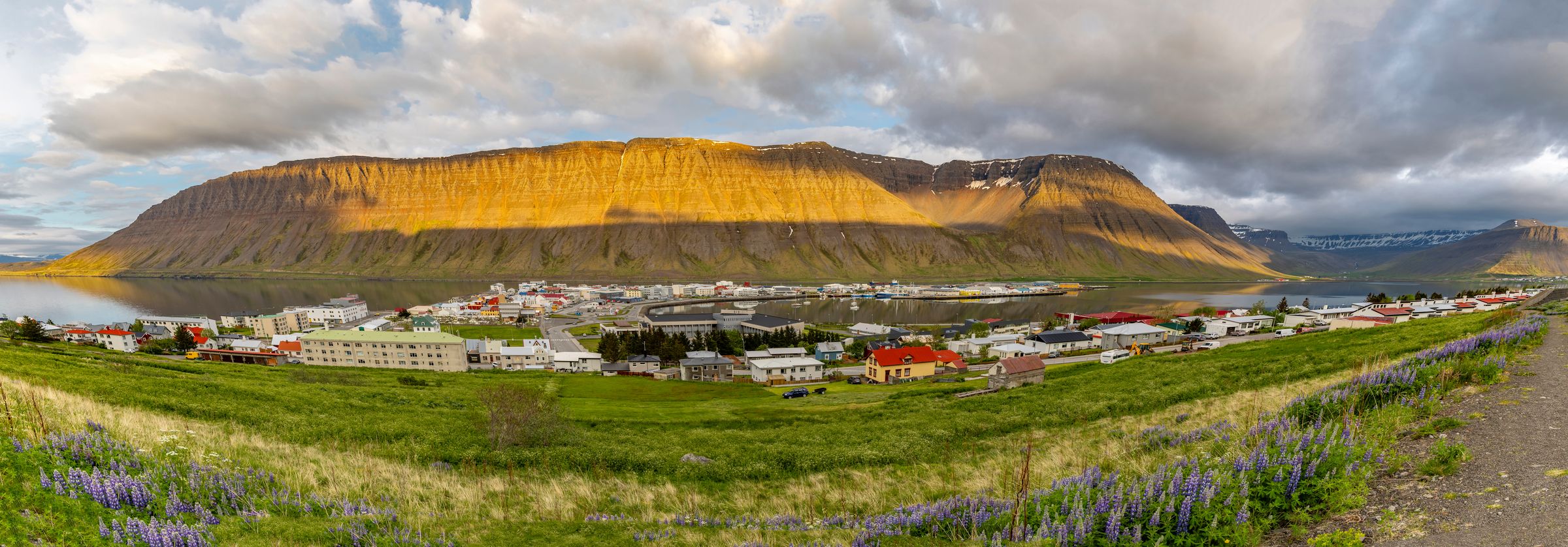 a panoramic view of Ísafjörður with a mountain in the background .