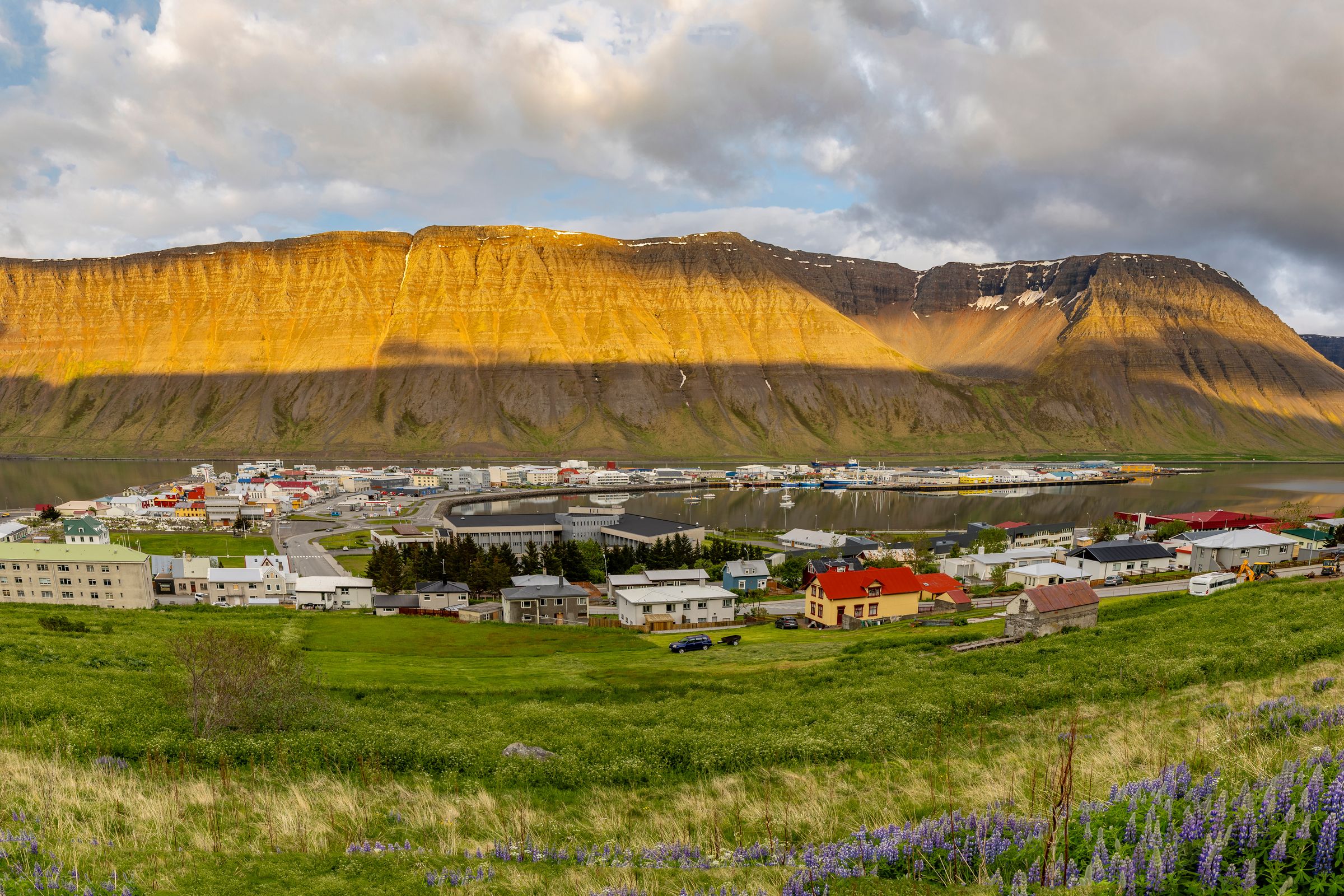a panoramic view of Ísafjörður with a mountain in the background .