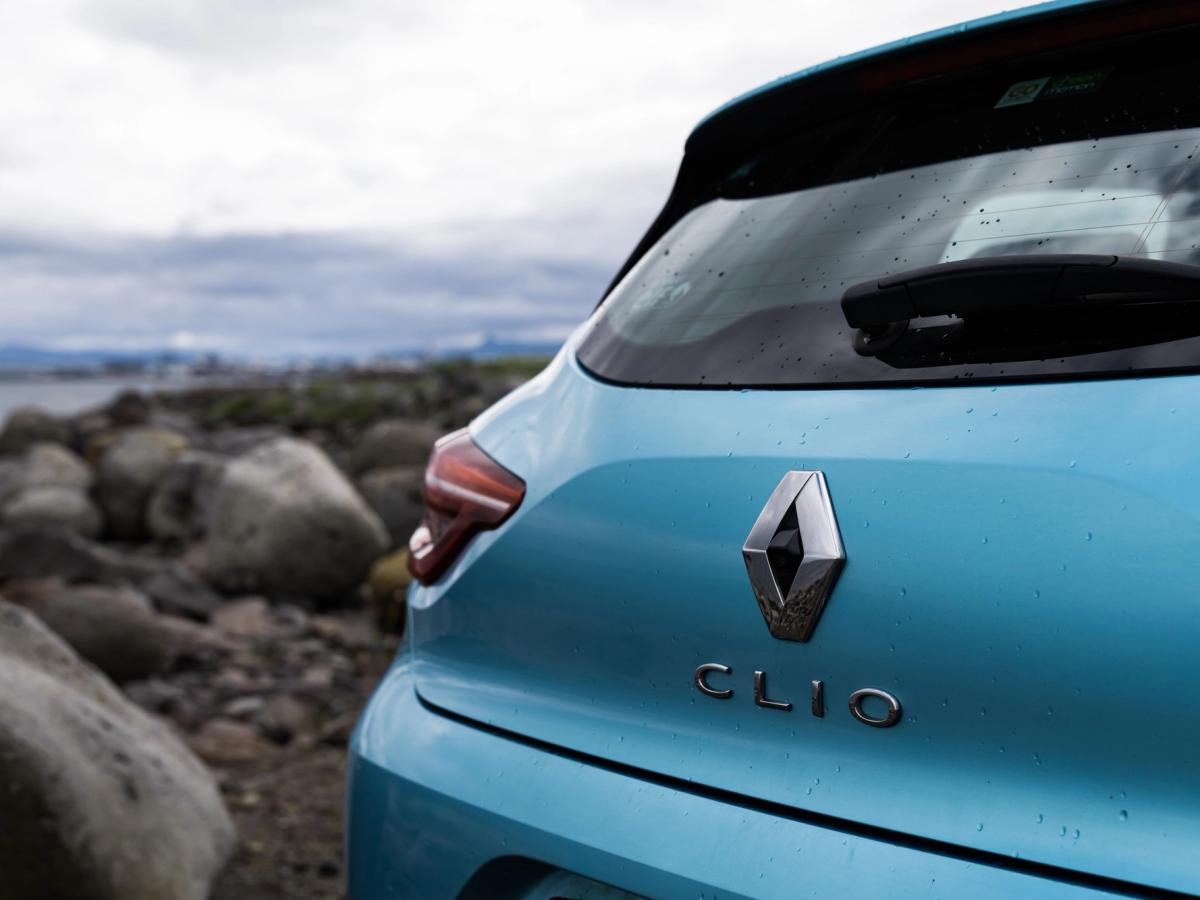 Clio-Heckemblem „Coastal“ Nahaufnahme des Renault Clio mit Heckemblem und Rückleuchte an einer felsigen Küste