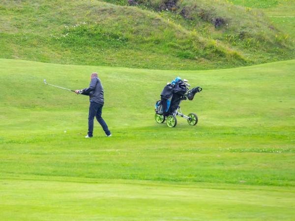 Man playing golf on a green field