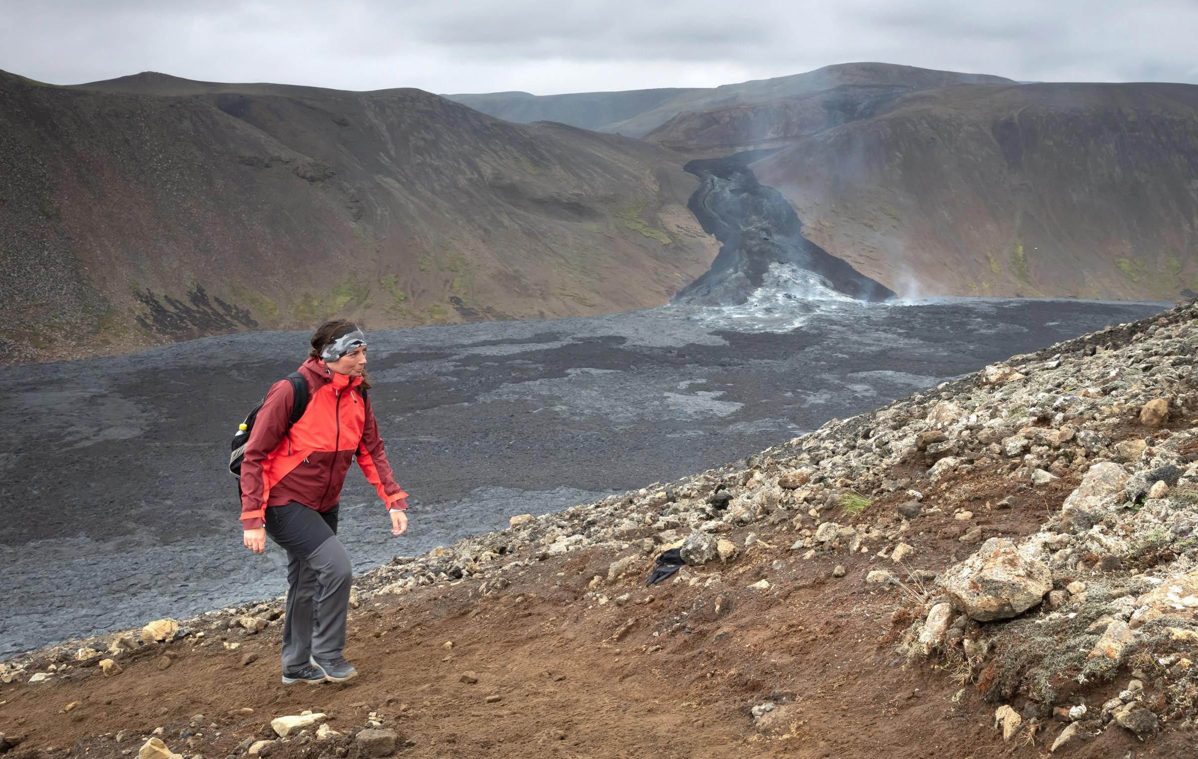 A view of a hiking path in Iceland with volcanic activity in the background