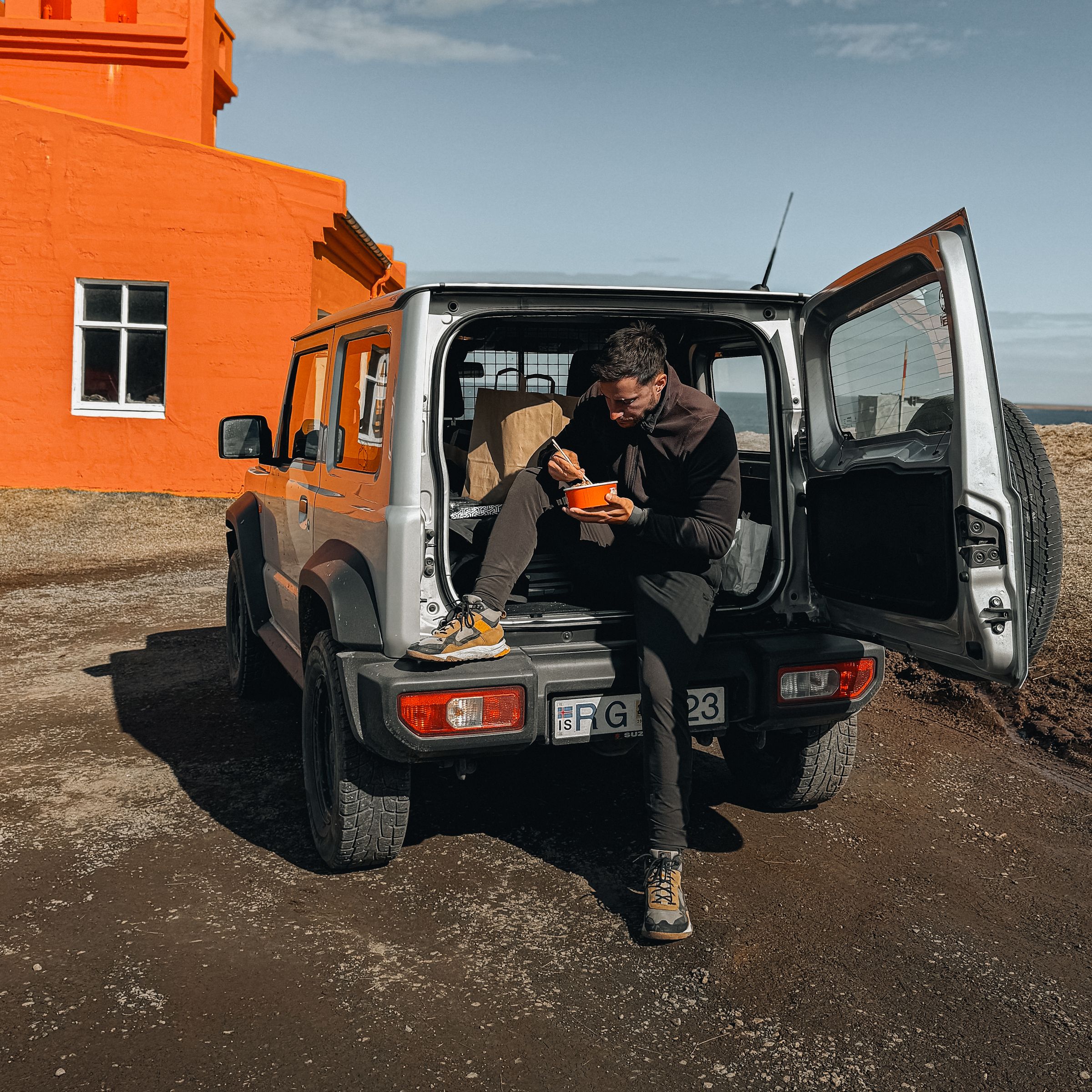 a man sits in the back of a car with a license plate that says fg
