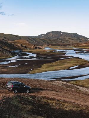 Toyota Land Cruiser rental car with go car rental A Toyota Land Cruiser from Go Car Rental parked in Iceland with a captivating landscape backdrop featuring black sand beaches and the country's unique tectonic plates.