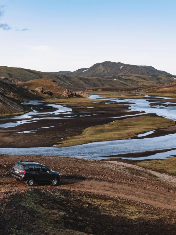 Toyota Land Cruiser rental car with go car rental A Toyota Land Cruiser from Go Car Rental parked in Iceland with a captivating landscape backdrop featuring black sand beaches and the country's unique tectonic plates.