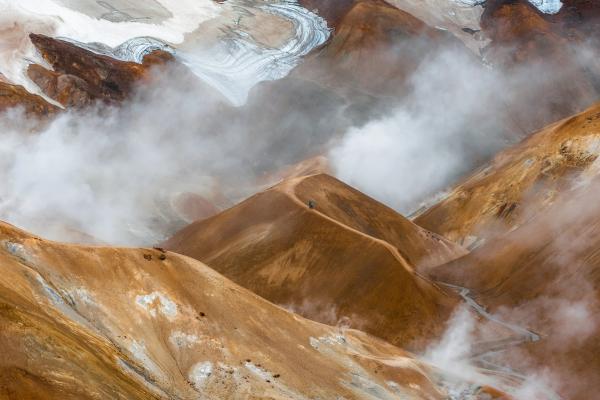 smoke is coming out of a volcano in the mountains at Kerlingarfjöll in Iceland.