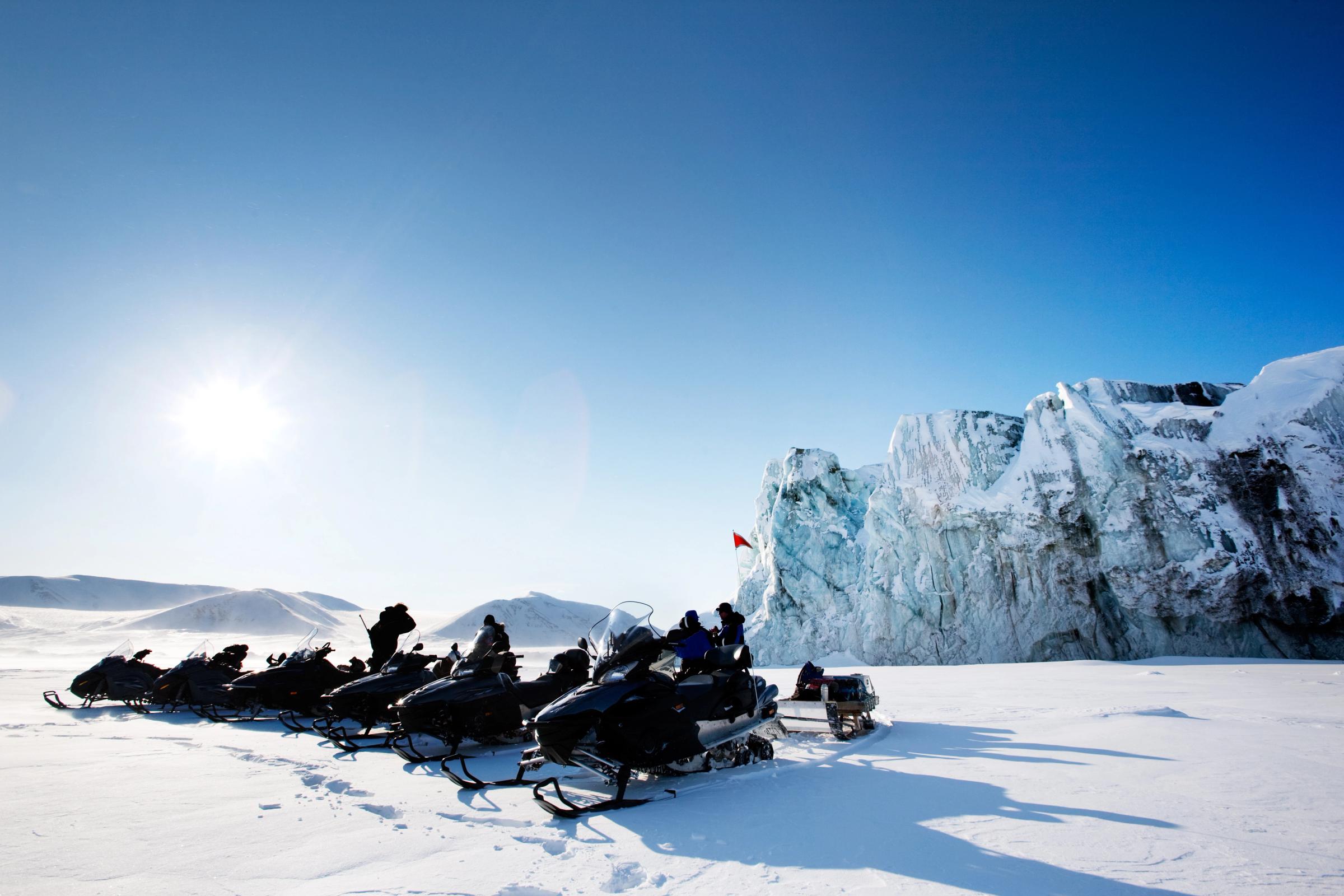 snowmobiles parked on a glacier