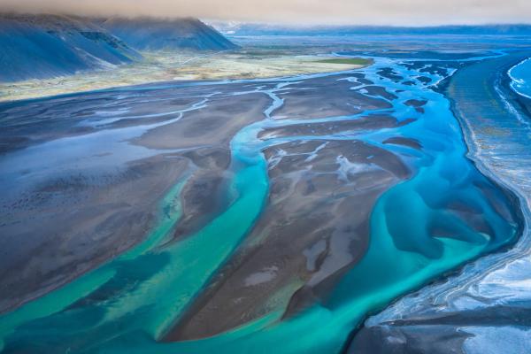 an aerial view of a a river glacier in Iceland