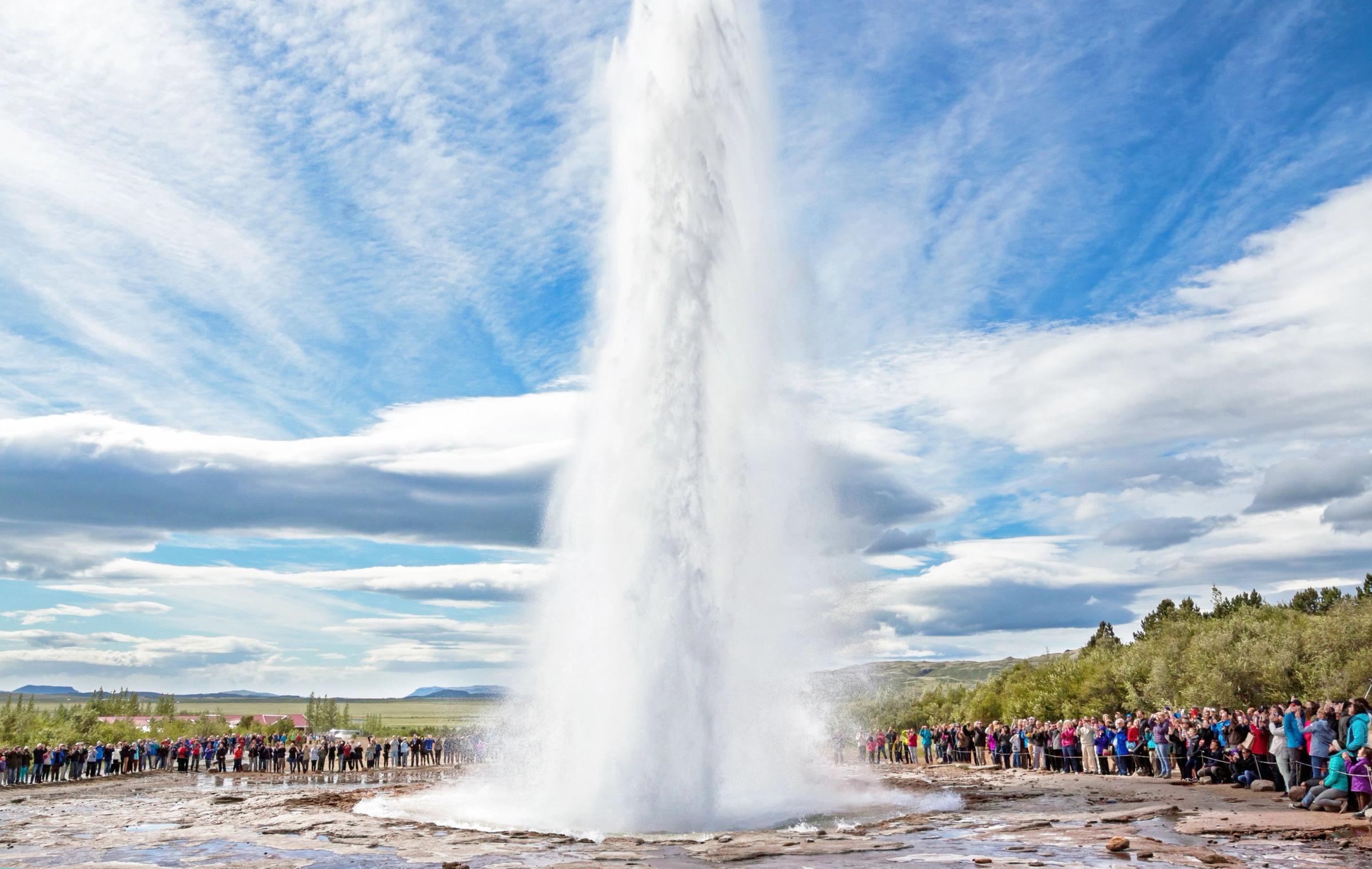 Strokkur Geysir eruptingin front of a big crowd