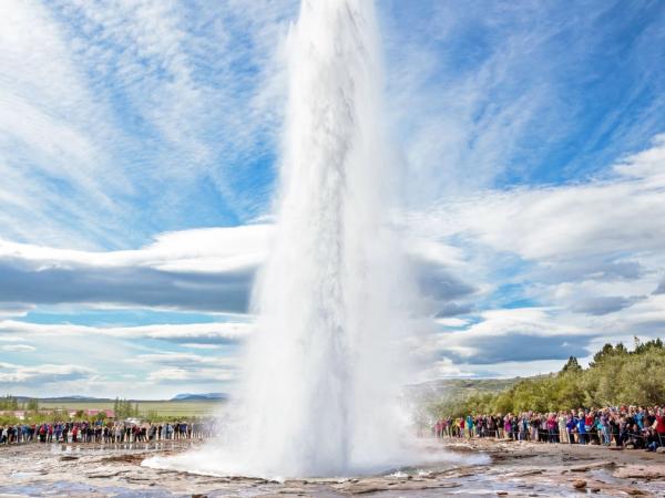 Strokkur Geysir eruptingin front of a big crowd