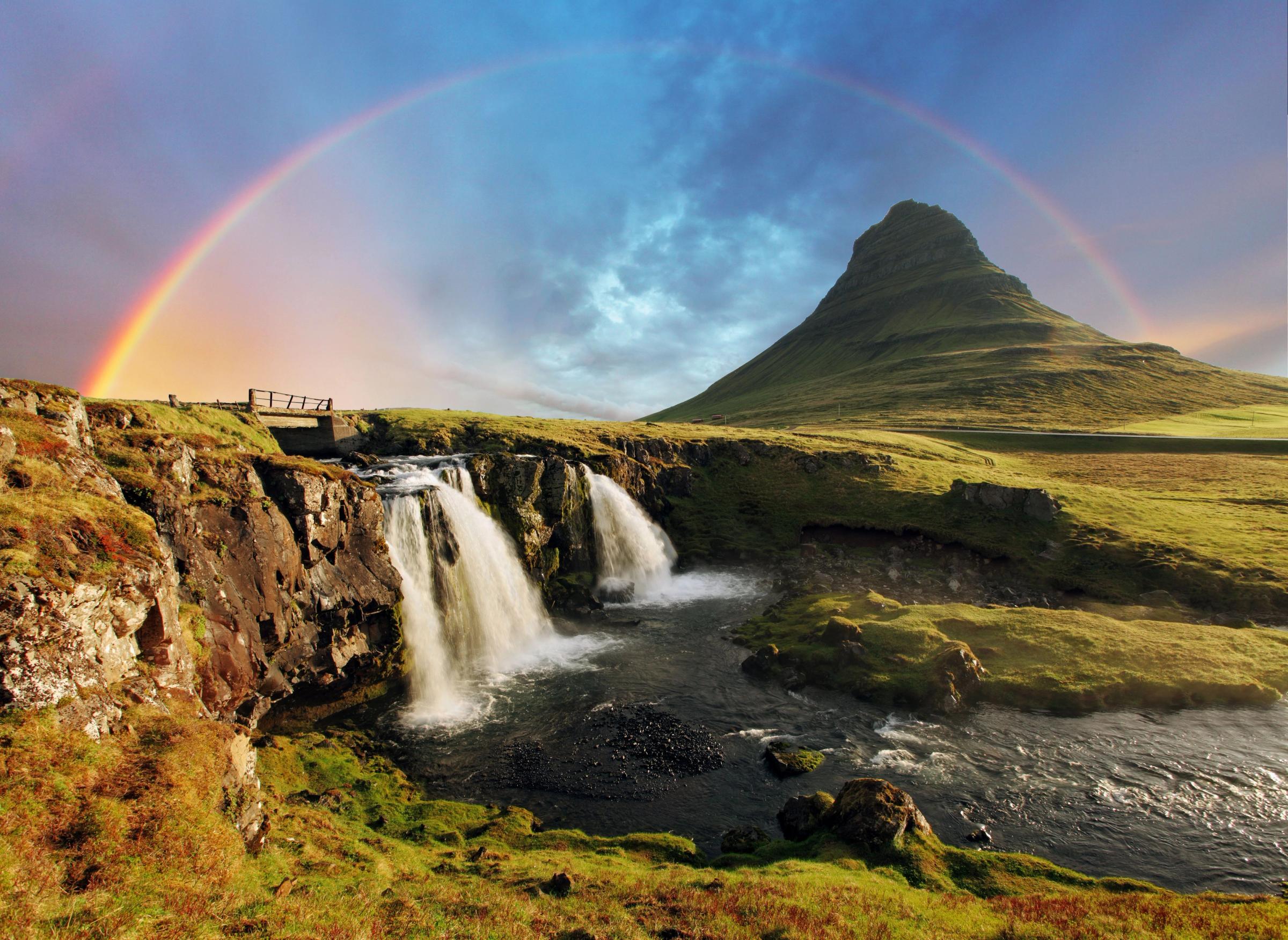 Kirkjufellsfoss and Kirkjufells with a rainbow