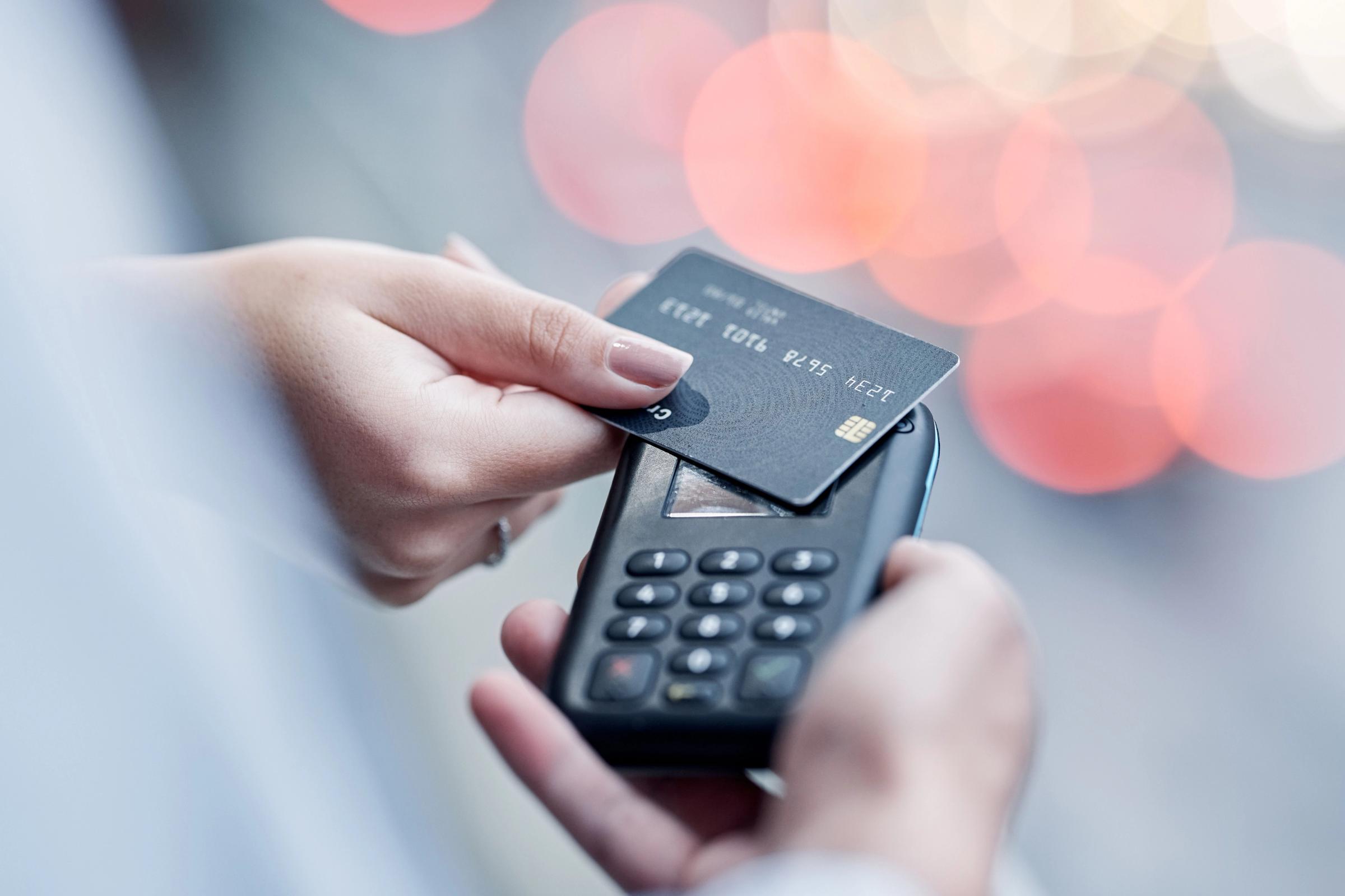 Woman taping her credit card for a contactless payment Credit card, pos payment and hands of people, woman or courier delivery man with retail sales machine. Logistics supply chain, shipping distribution and shopping customer with financial fintech tap