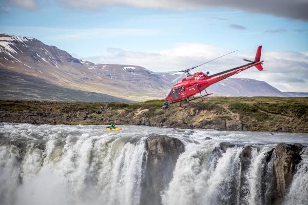 The making of flyover iceland a helicopter flying over a waterfall to film iceland for flyover iceland