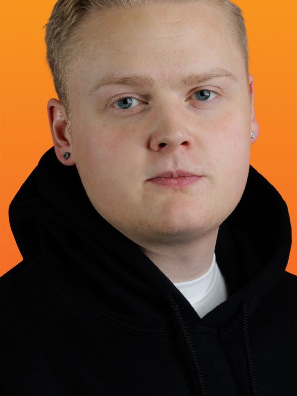 a young man wearing a black hoodie looks at the camera