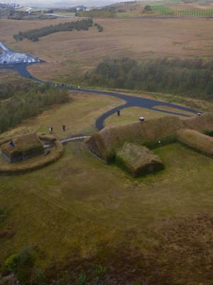 an aerial view of a house on top of a grassy hill .