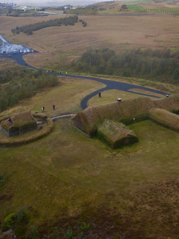 an aerial view of a house on top of a grassy hill .