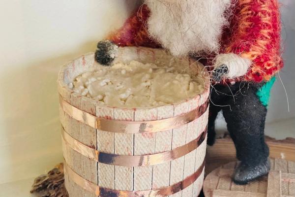 a figurine of a man with a beard is standing next to a sign that says skyrjarmur