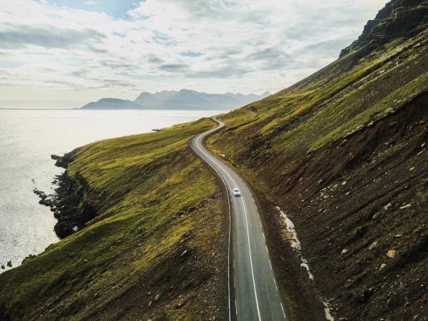 an aerial view of a car driving down a winding road .