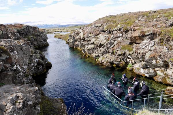 a group of people are in a boat in a river .