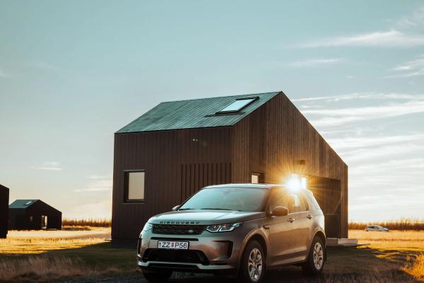 A Land Rover Discovery Land Rover Discovery Sport parked during Icelandic sunset