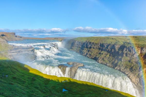 Gullfoss waterfall in iceland with a rainbow in the background.