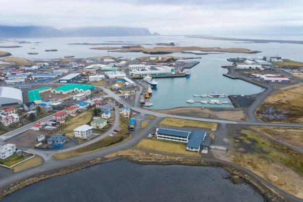 an aerial view of a small town next to a body of water .