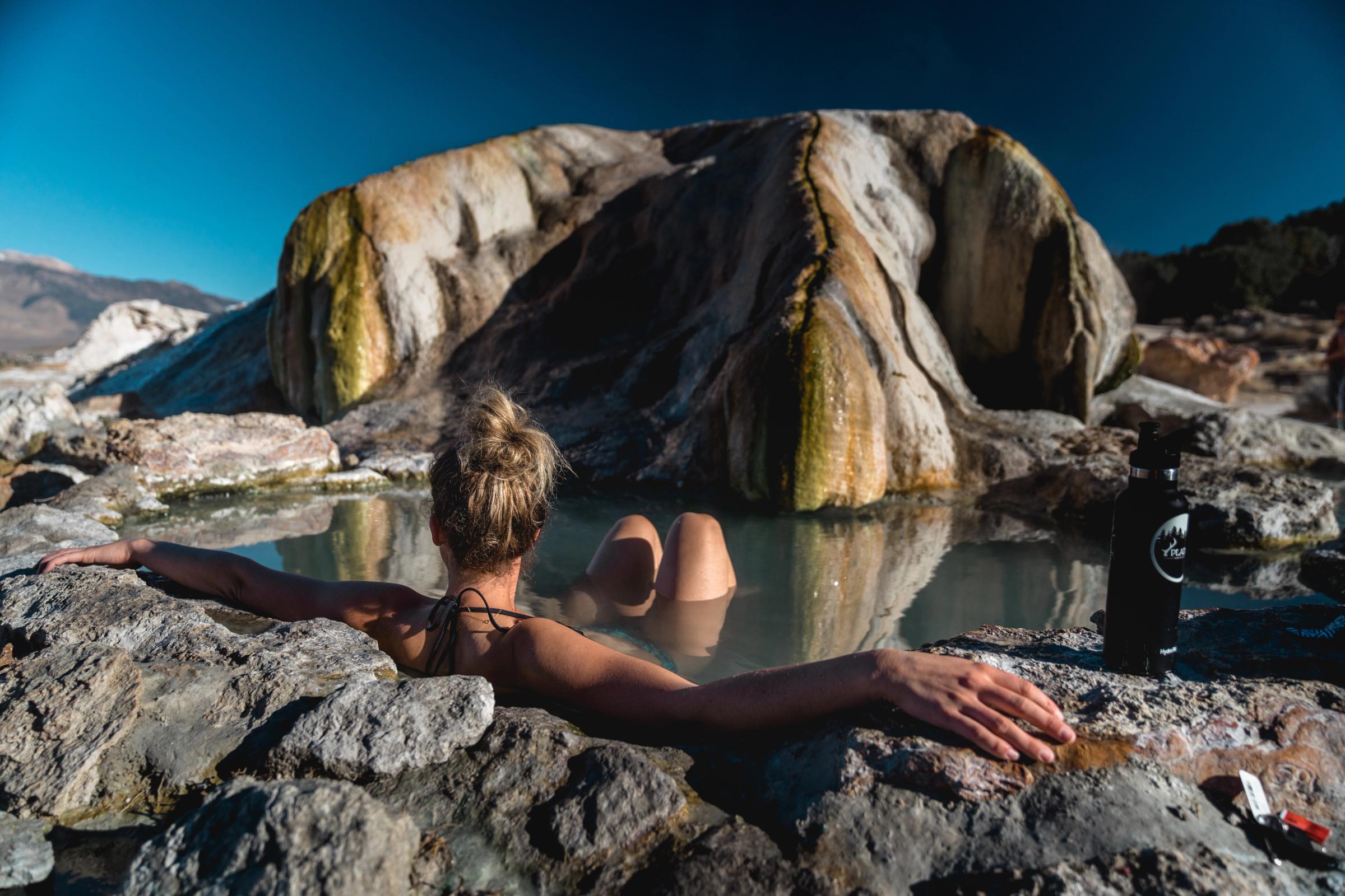 woman bathing in natural hot spring 