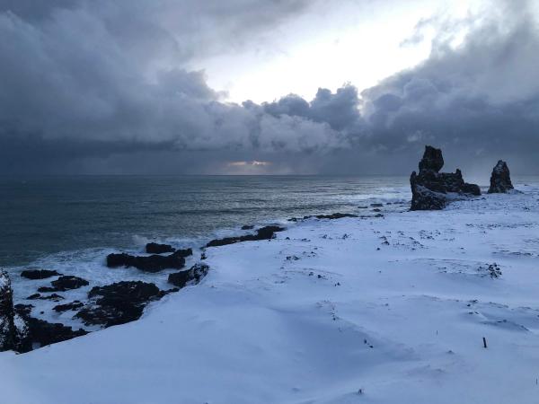 Cliffs with two basalt pinnacles covered by snow