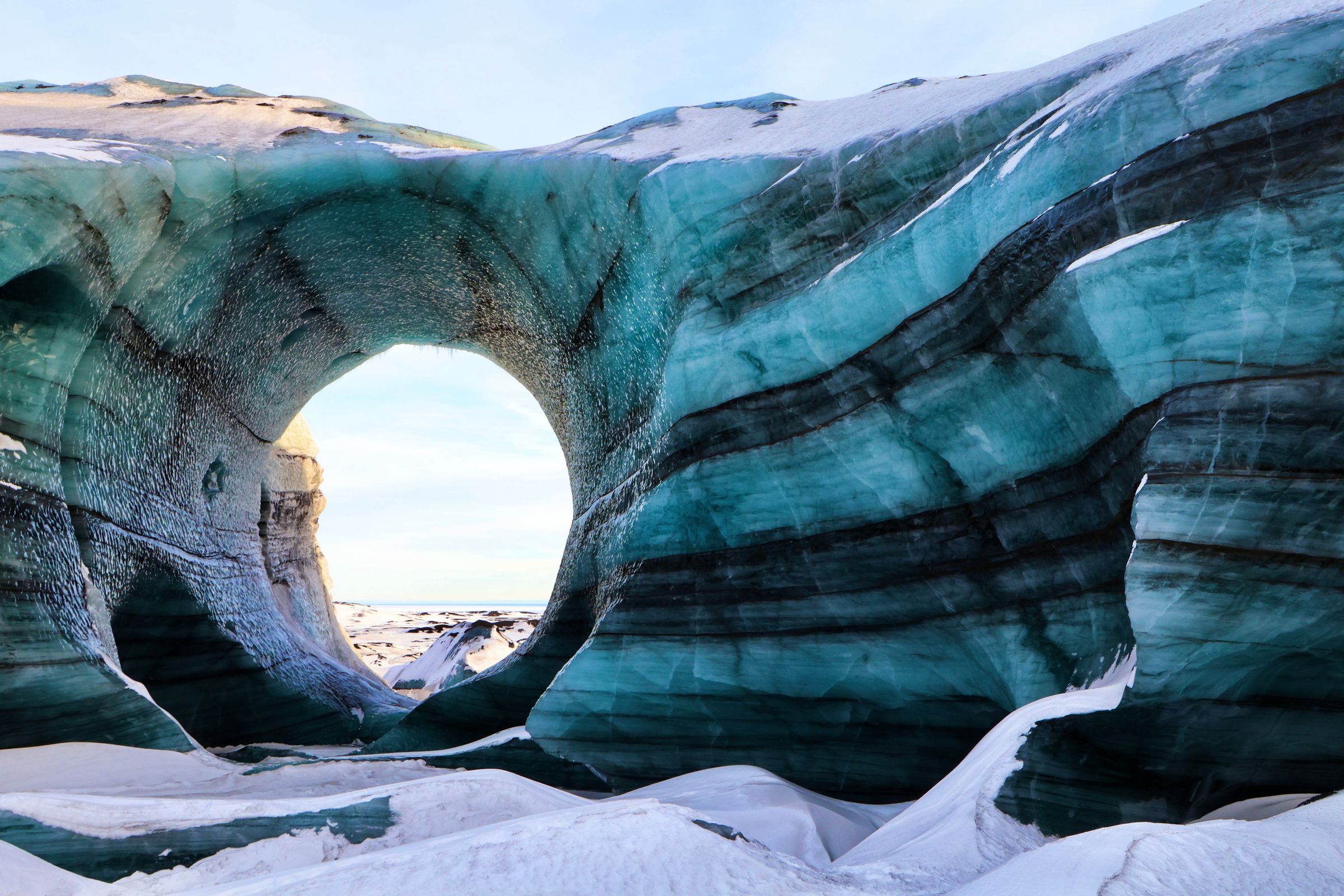 there is a large arch in the middle of the ice cave at Katla in iceland.