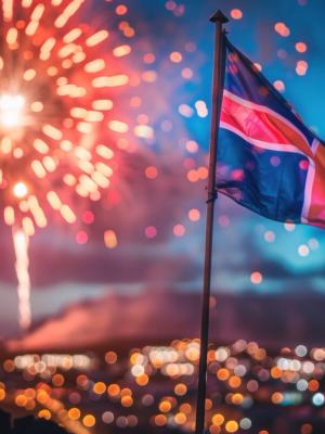 Iceland flag is flying in front of a fireworks in downtown Reykjavík in Iceland.