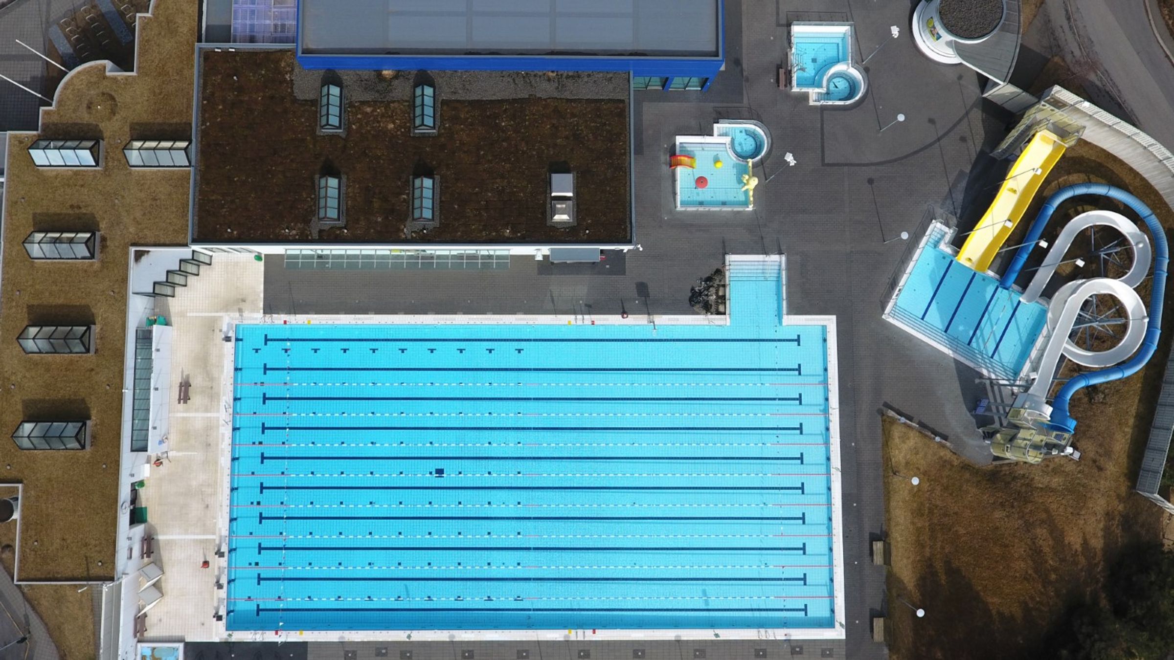 an aerial view of a large swimming pool and water slide .
