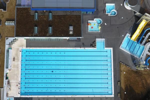 an aerial view of a large swimming pool and water slide .