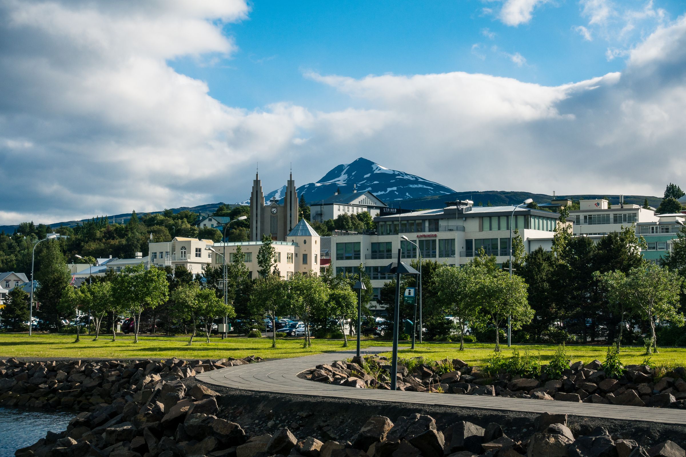 a city with a mountain in the background and a path leading to it .