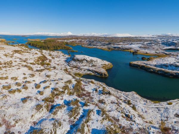 landscape with lake myvatn covered with a layer of freshly fallen snow