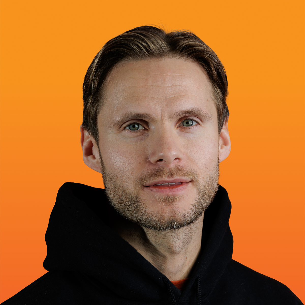 a man with a beard is wearing a black hoodie