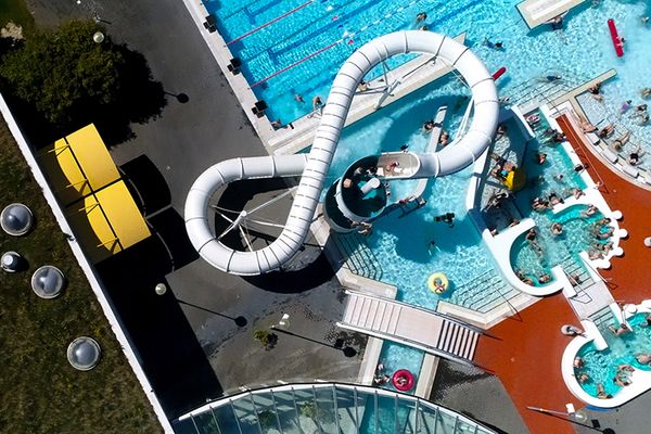 an aerial view of a water park with a water slide and swimming pool .