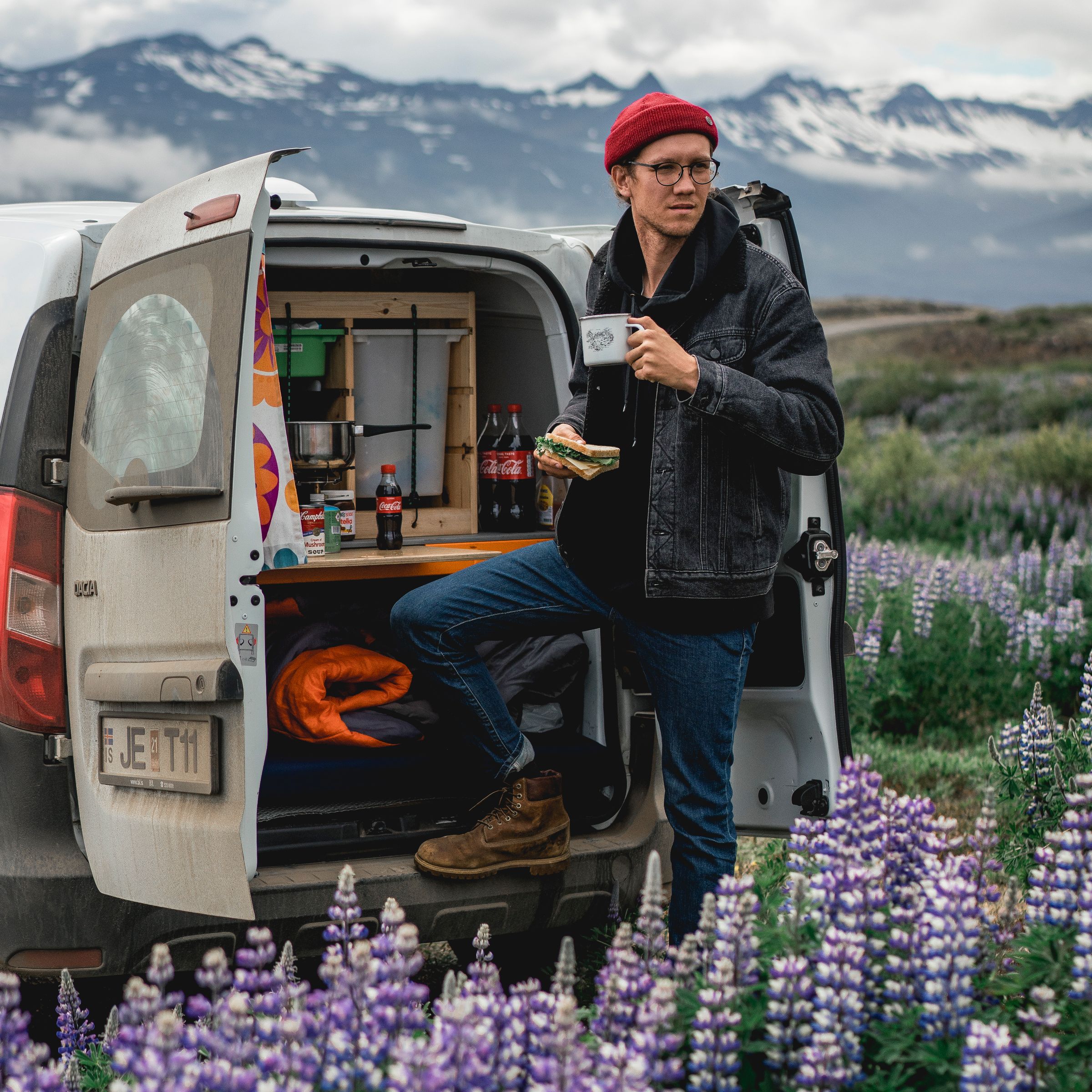 a man standing next to a white van with a license plate that says f.eptn