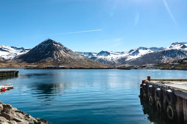 a lake with mountains in the background and a dock in the foreground .