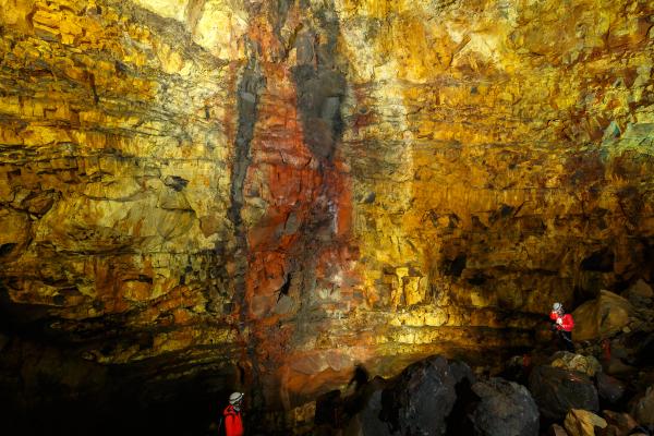 two people are standing inside a volcano in Iceland