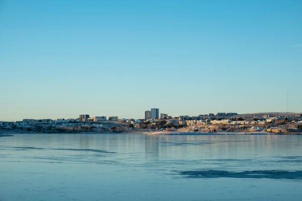 there is a city in the distance and a large body of water in the foreground .
