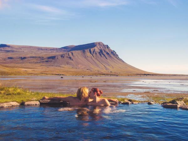 Couple kissing in a hot spring during a nice summer day in Iceland