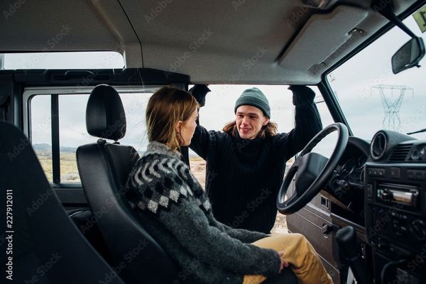 Two people in a car in Iceland, wearing winter clothes