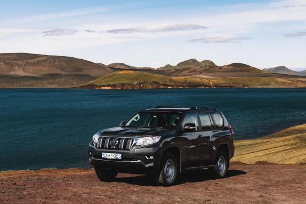 Toyota Land Cruiser Rental Car A robust Toyota Land Cruiser from Go Car Rental tackling off-road conditions in Iceland, showcasing the adventurous side of an Iceland self-drive to