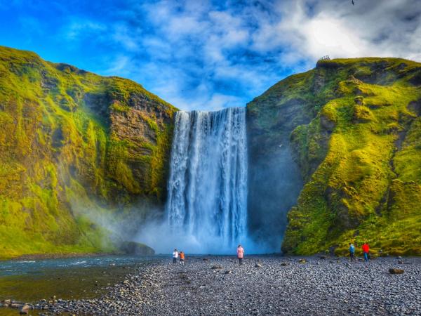 people looking at Skógafoss waterfall