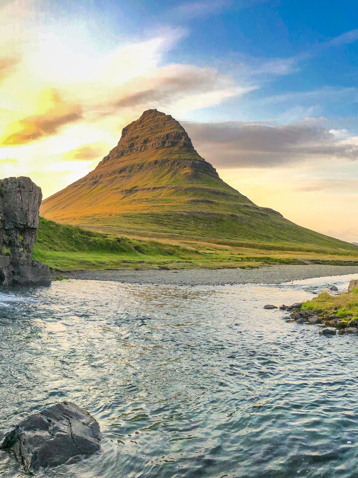 Panoramic picture of Kirkjufellsfoss Waterfall with Kirkjufell Mountain behind it